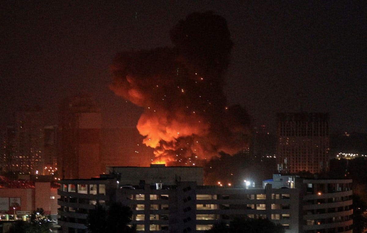 Kyiv skyline engulfed in smoke and flames after a large-scale overnight drone and missile strike by Russian forces.