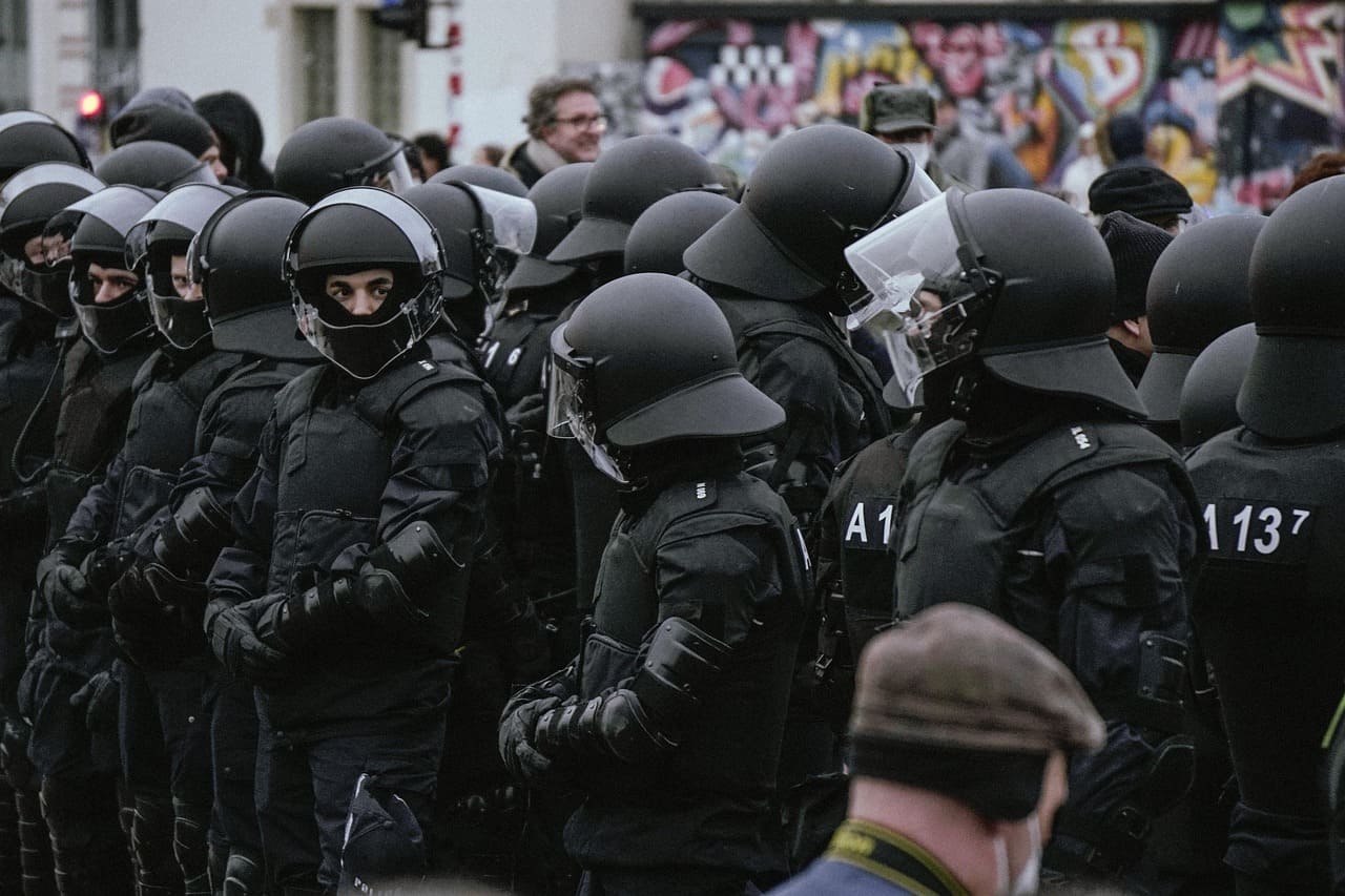Federal agents from the U.S. National Security Guard confront protesters during a raid on a cannabis garden near Camarillo.