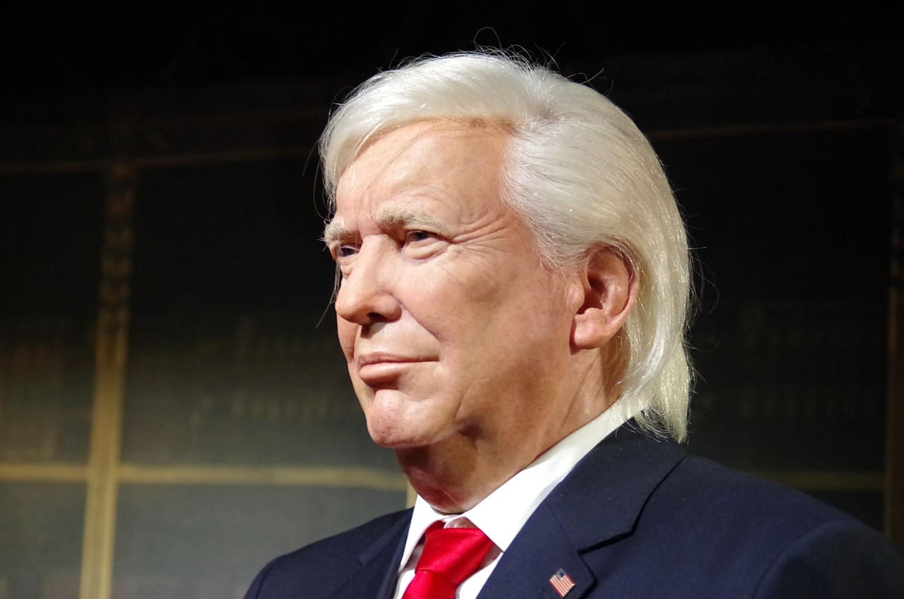 Donald Trump speaking at a podium during a press conference on trade policy.