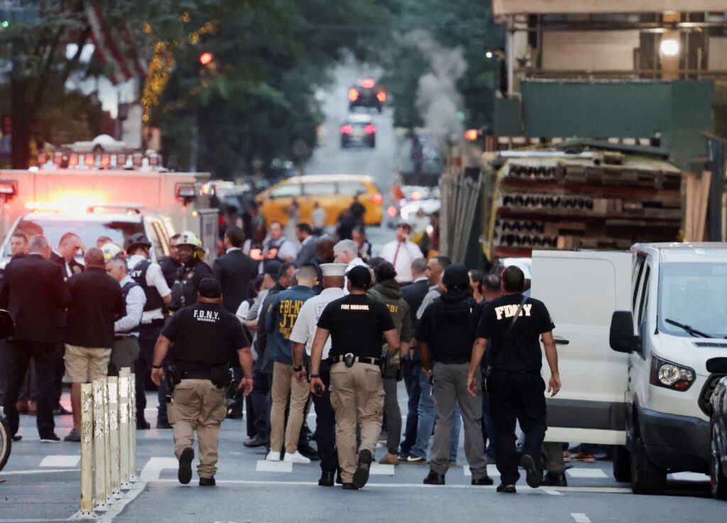 NYPD officers secure the perimeter outside the Solara Building following the deadly Midtown office shooting.