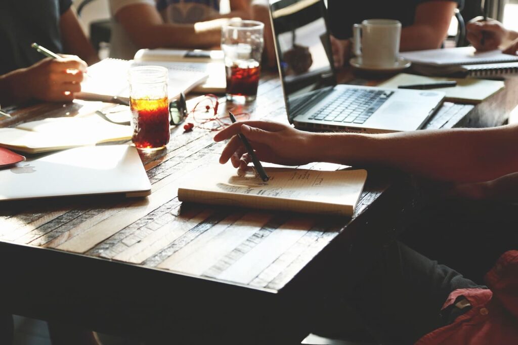 Group of diverse professionals sitting around a table, actively discussing startup ideas and strategies.