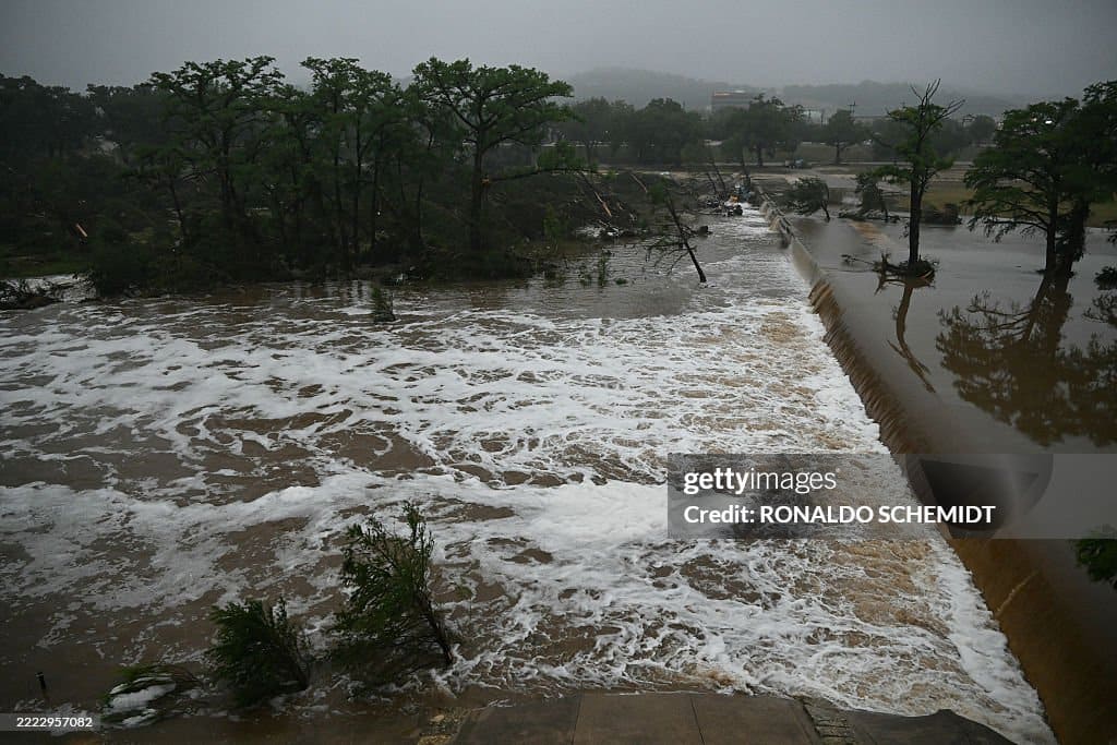 Tragedy in Texas: Over 100 Lives Lost in Devastating Flash Flood – aerial view of submerged homes and rescue operations in progress
