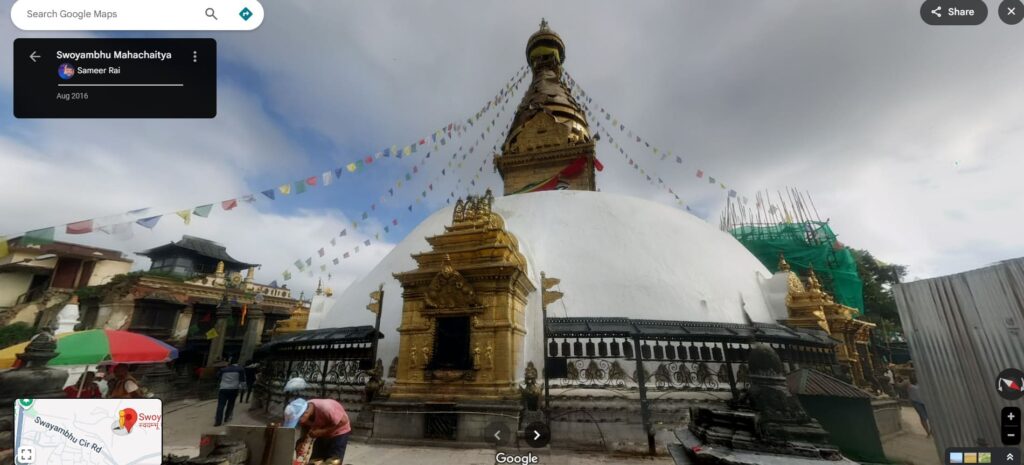 Image-of-swyambhunath-stupa-as-seen-in-street-view (1) 360° Street View of Swayambhunath Stupa, also known as the Monkey Temple, overlooking Kathmandu Valley with prayer flags and golden spires.
