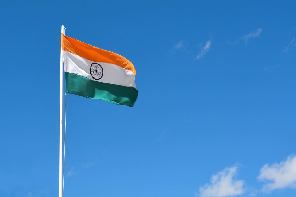 indian-flag- (1) Indian national flags fluttering proudly in the sky against a bright background, symbolizing patriotism and Independence Day celebrations.