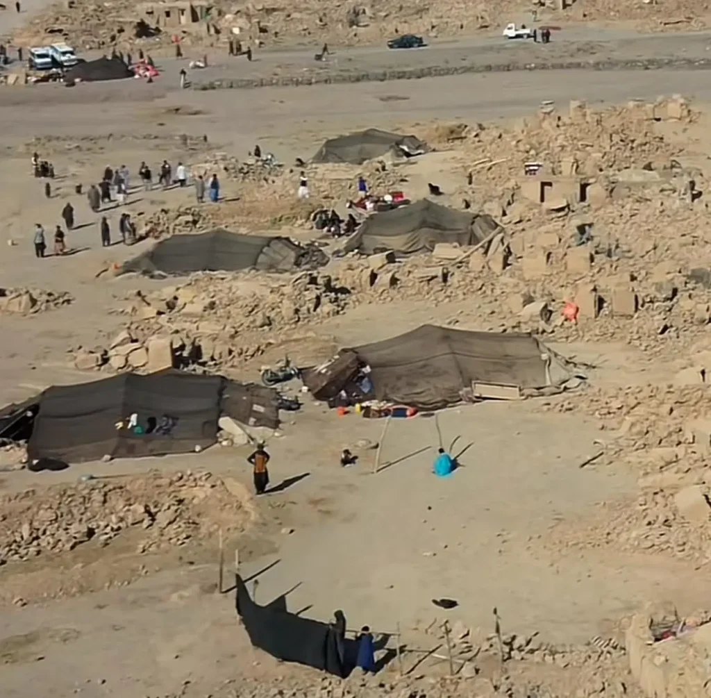 Collapsed buildings and rescue workers searching through rubble after the devastating Afghanistan earthquake.