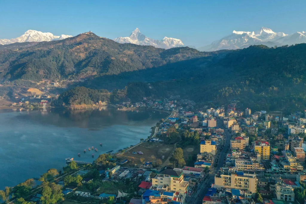 Panoramic view of Pokhara city with Phewa Lake and the Annapurna mountains in the background.