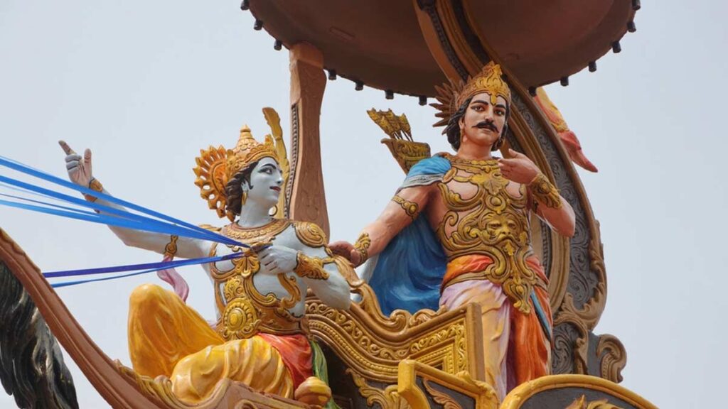 Lord Krishna guiding Arjuna on the battlefield of Kurukshetra, delivering the teachings of the Bhagavad Gita.