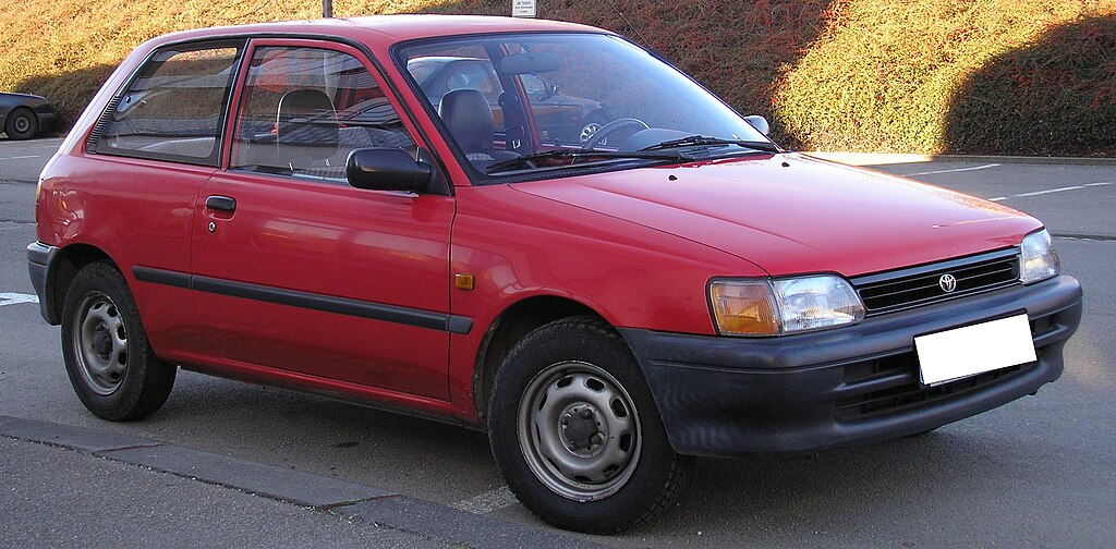 Toyota Starlet parked on a street in Nepal, showing its compact hatchback design