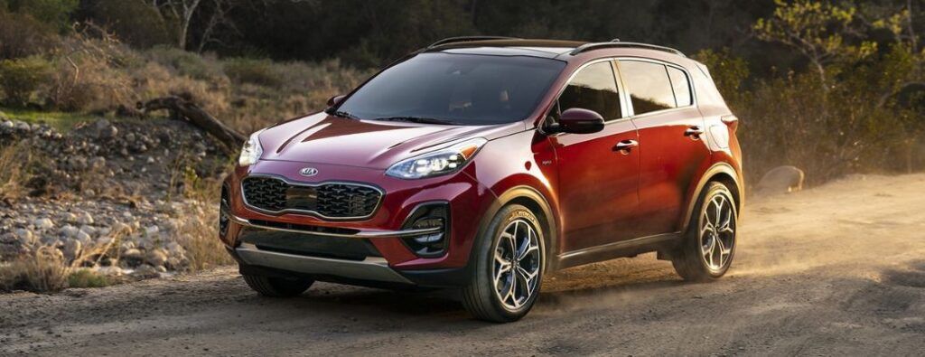 kia-sportage-car 2025 Kia Sportage SUV parked on a scenic road, highlighting its sleek design and modern features.
