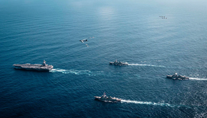 Defense officials examine classified strategic maps outlining potential U.S.–China conflict scenarios around Taiwan.