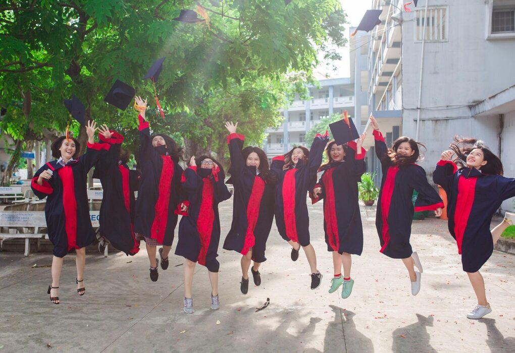 Youth jumping over a graduation degree during a convocation ceremony, symbolizing employability challenge.