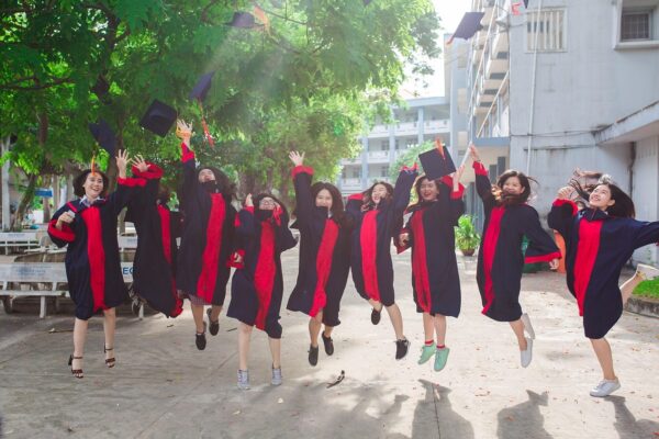 Youth jumping over a graduation degree during a convocation ceremony, symbolizing employability challenge.