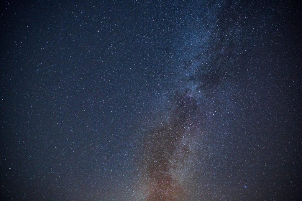 Starlit night in Langtang Valley with Himalayan peaks silhouetted against the sky.